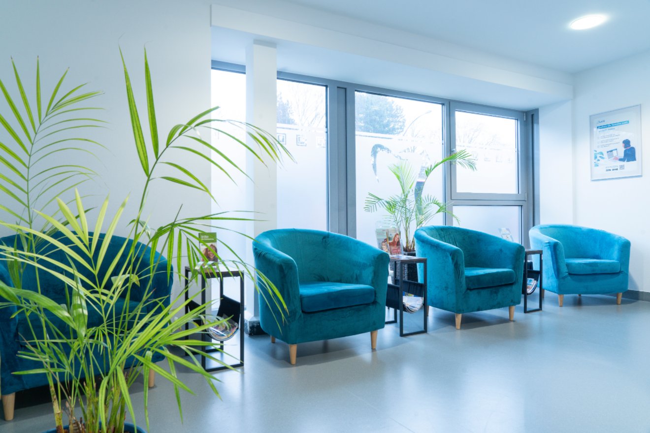 Blue seats and flowers in the Natalie Herzel Dental Clinic