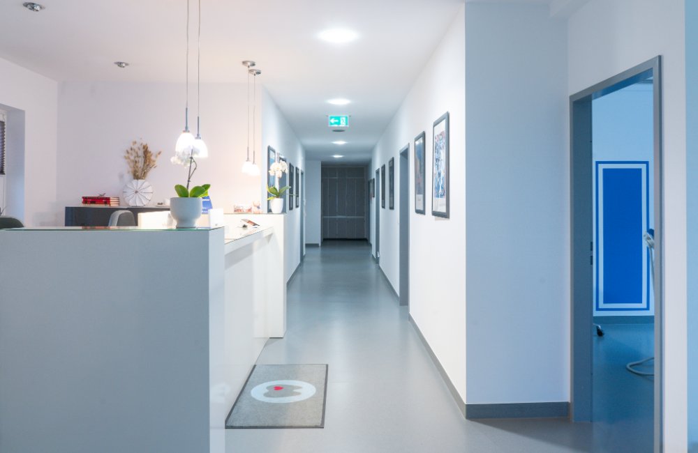 White corridor and reception in the Natalie Herzel Dental Clinic
